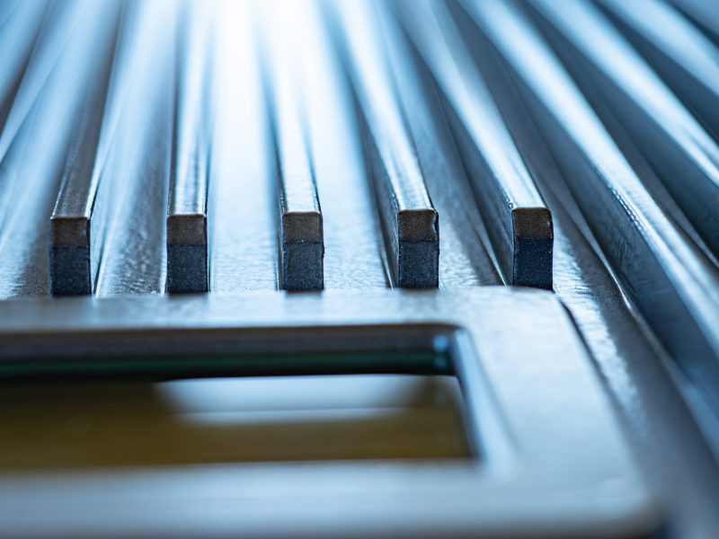 Close-up of a fluted metal surface next to a control panel on an unidentified automatic control device in a factory. The concept of secret military production